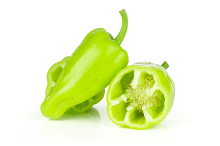 Group of one whole two halves of light green bell pepper isolated on whiteの写真素材