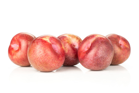 Lot of whole fresh pluot interspecific plums variety isolated on whiteの写真素材