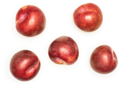 Group of three whole fresh pluot interspecific plums variety flatlay isolated on white