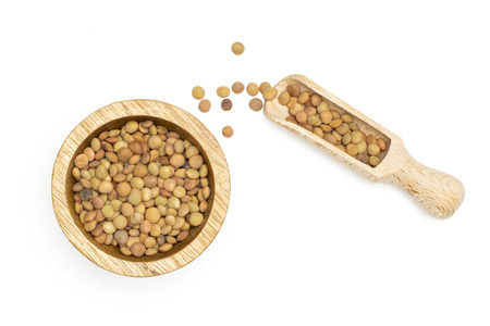 Lot of whole raw green lentil seeds in wood bowl and scoop flatlay isolated on whiteの写真素材