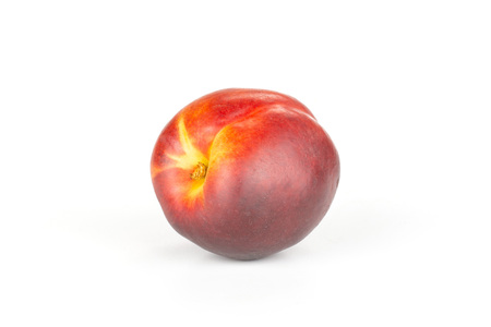One whole ripe deep red nectarine isolated on whiteの写真素材
