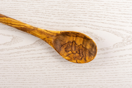 One whole kitchen tool olive wood spoon flatlay on grey woodの写真素材