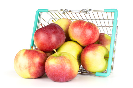 Lot of whole fresh red apple james grieve variety with shopping basket isolated on white backgroundの写真素材