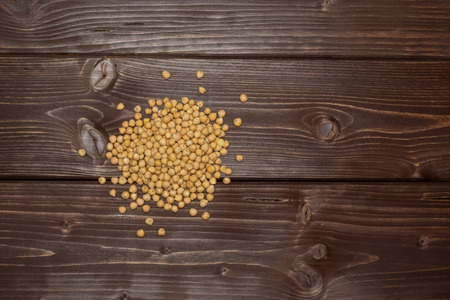 Lot of whole raw chickpeas kabuli variety flatlay on brown woodの写真素材