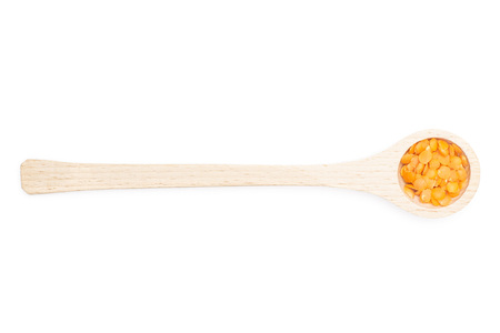 Lot of whole raw red lentils with wooden spoon flatlay isolated on white backgroundの写真素材