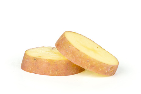 Group of two slices of fresh red potato francelina variety isolated on white backgroundの写真素材