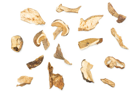 Lot of slices of edible dry brown mushroom boletus edulis variety flatlay isolated on white backgroundの写真素材