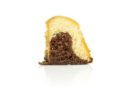One slice of fresh baked marble gugelhupf sweet bread variety isolated on white backgroundの写真素材