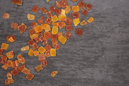 Lot of slices of dry papaya flatlay on grey stoneの写真素材