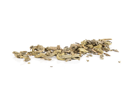 Lot of pieces of dry green tea line isolated on white backgroundの写真素材