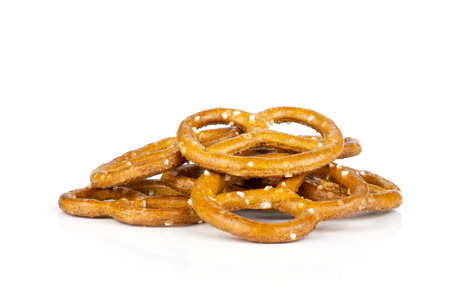 Lot of whole mini salted pretzels stack isolated on white background