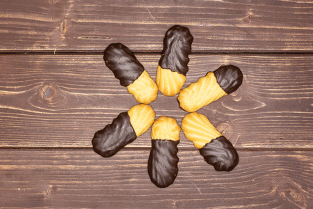 Group of six whole lazy cookie with chocolate flatlay on brown wood