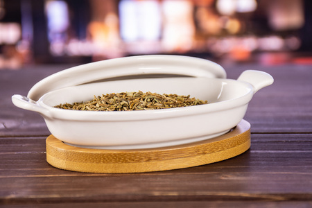 Lot of whole roman caraway seeds in a ceramic stewpan in a restaurant