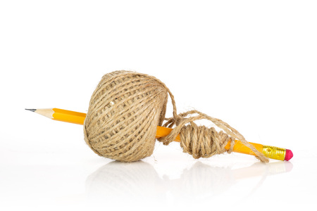 One whole yellow pencil with jute spool isolated on white backgroundの写真素材