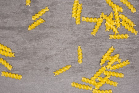 Lot of pieces of raw italitan yellow pasta torti flatlay on grey stoneの写真素材