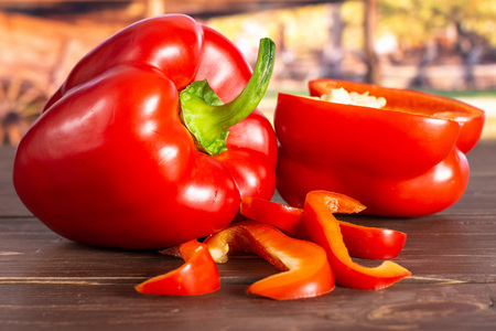 Group of one whole one half four slices of bulgarian red bell pepper with cart in backgroundの写真素材