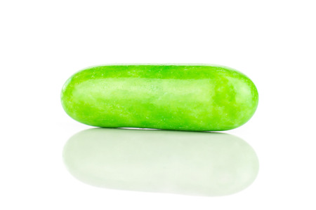 One whole green sweet licorice comfit isolated on white background