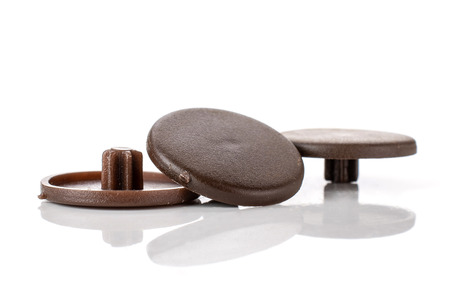 Group of three whole brown plast caps work item isolated on white background