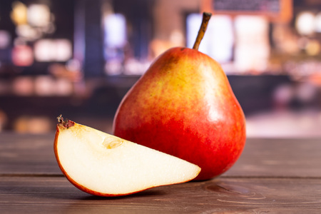 Group of one whole one slice of fresh red pear in a restaurantの写真素材