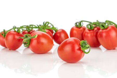 Lot of whole fresh red tomato cherry isolated on white backgroundの写真素材