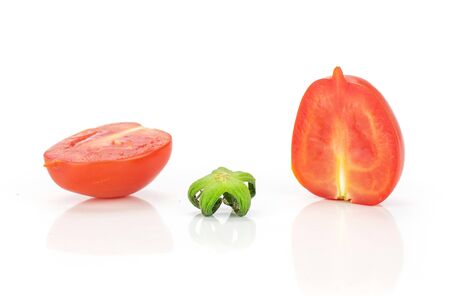 Group of two halves one piece of fresh red tomato cherry isolated on white backgroundの写真素材