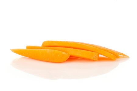 Group of four slices of peeled orange baby cut carrot in line isolated on white backgroundの写真素材