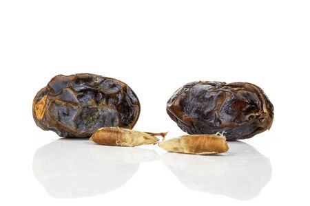 Group of two whole two pieces of dried brown date medjool isolated on white backgroundの写真素材