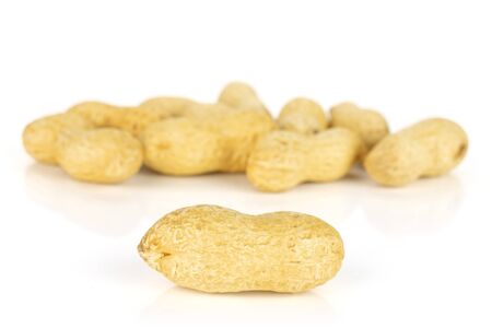 Lot of whole natural yellow peanut isolated on white background