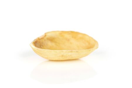 One piece of ripe green pistachio in closeup isolated on white