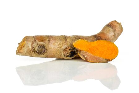 Group of one whole one slice of bright turmeric rhizome orange flesh isolated on white backgroundの写真素材
