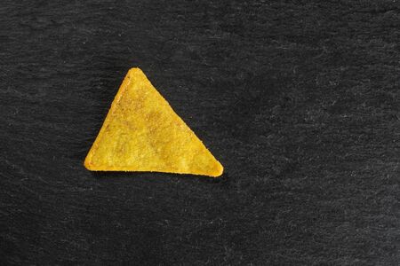 One whole cheese tortilla chips flatlay on grey stoneの写真素材