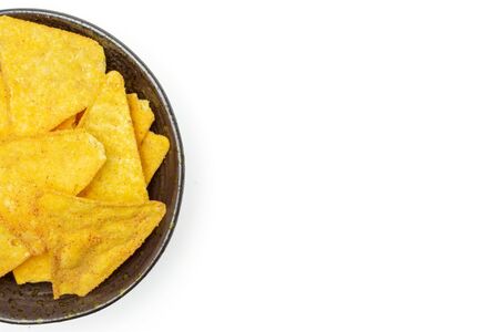 Lot of whole cheese tortilla chips copyspace right on grey ceramic plate flatlay isolated on white backgroundの写真素材