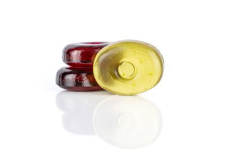 Group of three whole colourful hard candy two wine one yellow isolated on white backgroundの写真素材