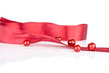 Group of five whole fresh red currant with red ribbon isolated on white backgroundの写真素材