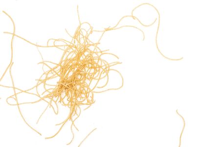 Lot of pieces of thin raw pasta noodles flatlay isolated on white background