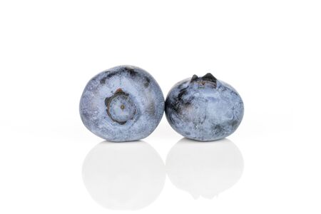 Group of two whole fresh blue bilberry isolated on white backgroundの写真素材