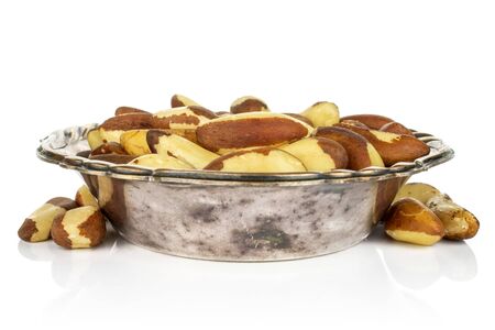 Lot of whole raw brown brazil nut in metal bowl isolated on white backgroundの写真素材