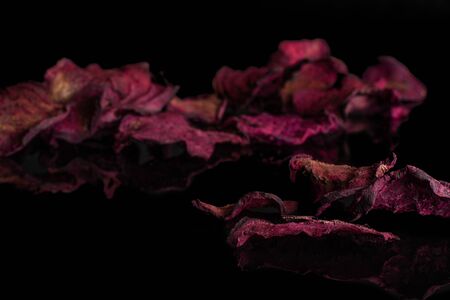 Lot of slices of dried red beetroot isolated on black glassの写真素材