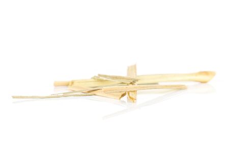 Lot of pieces of lemon grass of lingonberry strawberry fruit tea macro isolated on white backgroundの写真素材