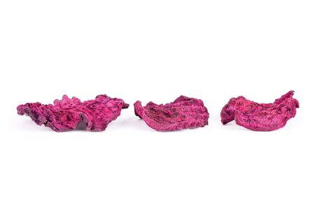 Group of three slices of dried red beetroot isolated on white background