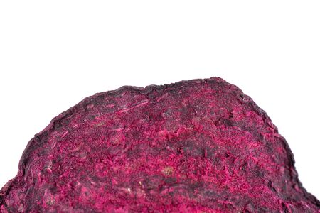 One slice of dried red beetroot in closeup isolated on white background