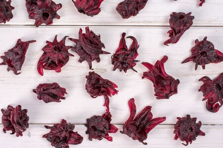 Lot of whole sweet red candied hibiscus flatlay on white woodの写真素材