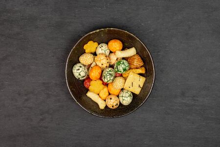 Lot of whole rice japan assortment in dark ceramic bowl flatlay on grey stoneの写真素材