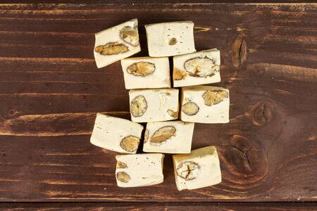 Lot of whole sweet white nougat flatlay on brown woodの写真素材