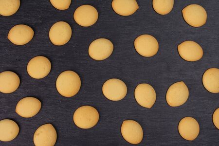 Lot of whole sweet golden sponge biscuit flatlay on grey stoneの写真素材