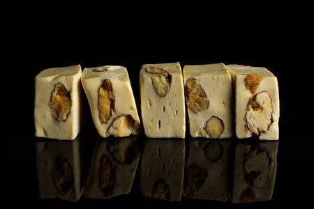 Group of five whole sweet white nougat isolated on black glassの写真素材