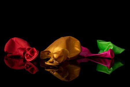 Group of four pieces of latex pastel ballon isolated on black glassの写真素材