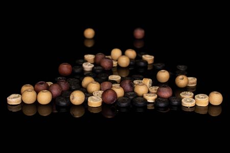 Lot of whole wooden bead stack isolated on black glassの写真素材