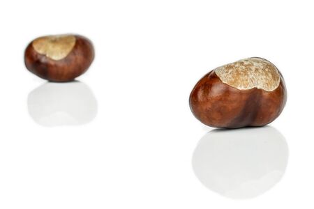 Group of two whole peeled autumnal green chestnut isolated on white backgroundの写真素材