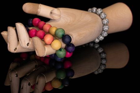 Lot of whole wooden bead with wooden hand isolated on black glass